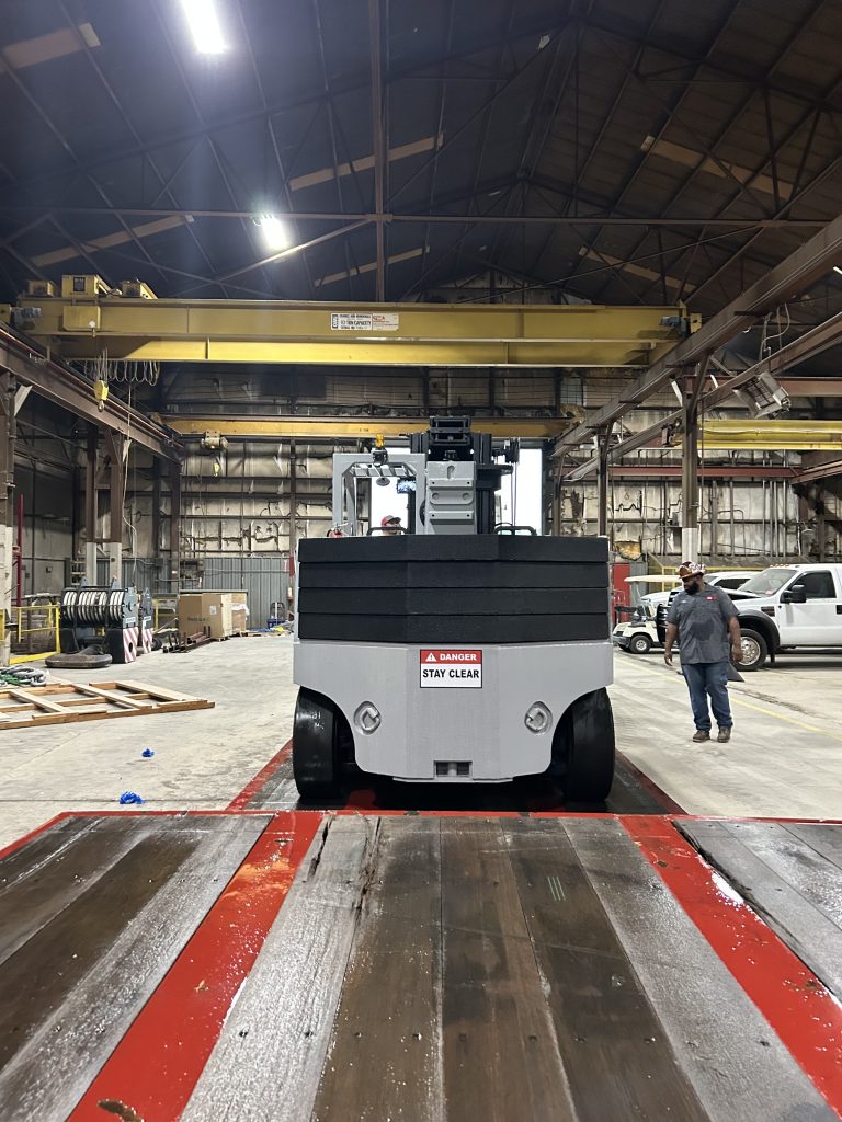 Customer unloading the refurbished Versa Lift 40/60 after delivery.