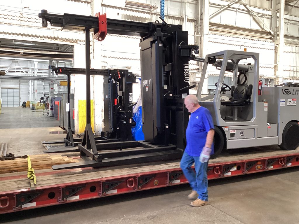 Loading the refurbished Versa Lift 40/60 onto a transport trailer.