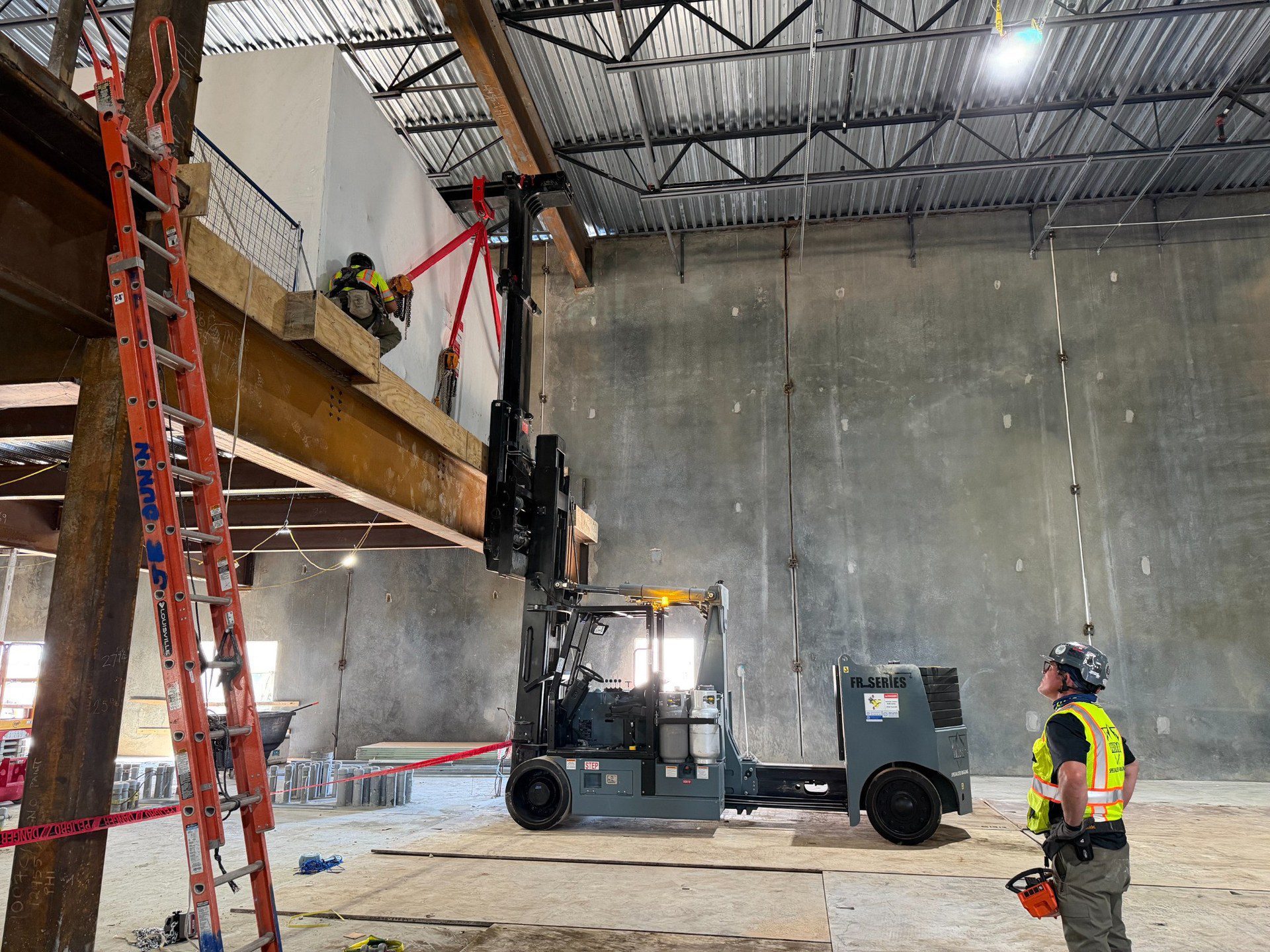 How Valor Specialized Rigging Moved a 15,000 lb Air Handler with a Hoist FR 40/60 A Valor crew member holding the remote controller while watching the air handler at mezzanine level